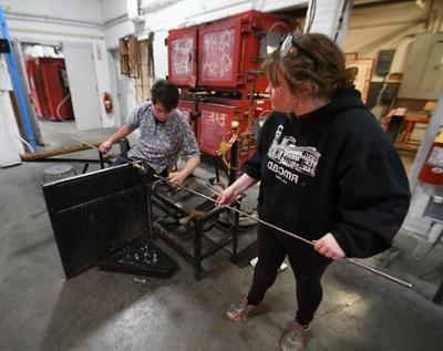 community member working with glass artist